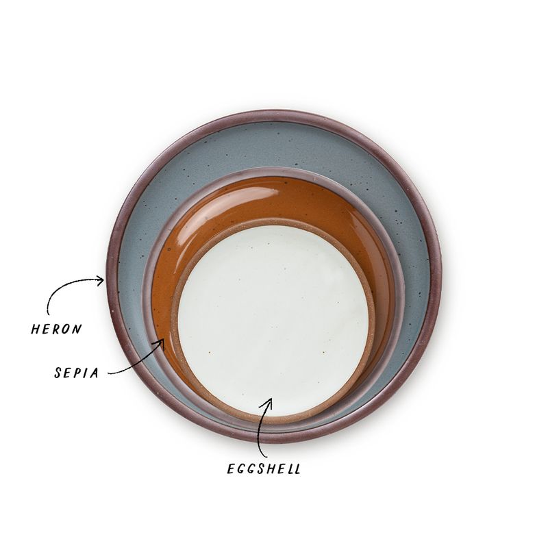 A stack of 3 plates in Dinner, Side, and Cake sizes in a blue-grey, glossy caramel brown, and cool white colors.