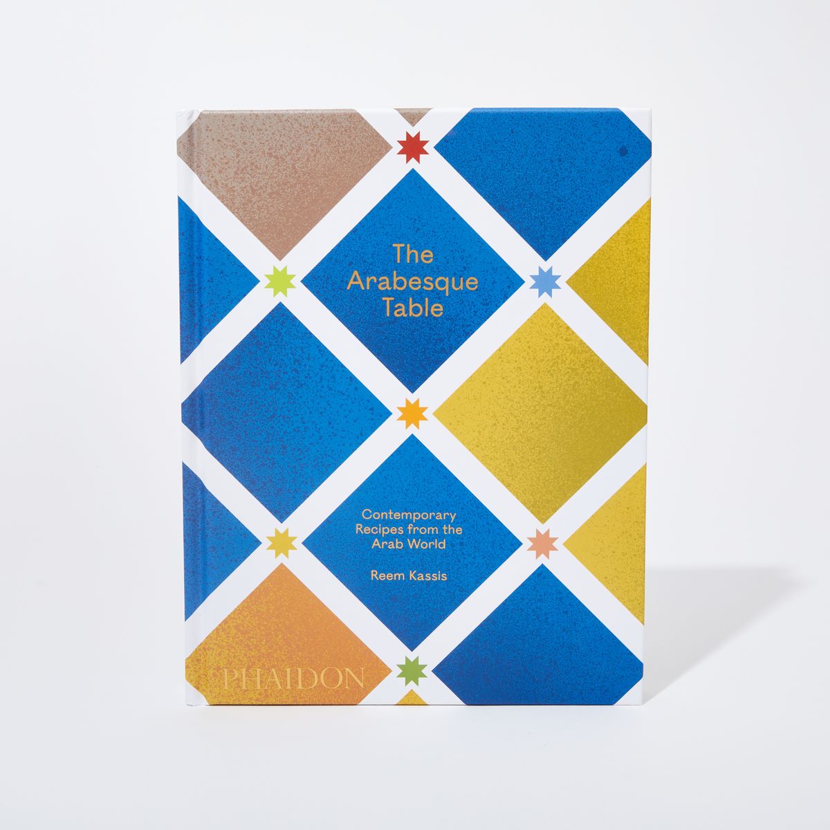 Book cover with a blue and yellow geometric square pattern and the title "The Arabesque Table"