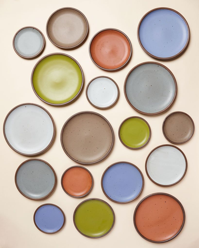 A grouping of East Fork plates in varying sizes in Eggshell, Celery, Morel, Utah and Soapstone
