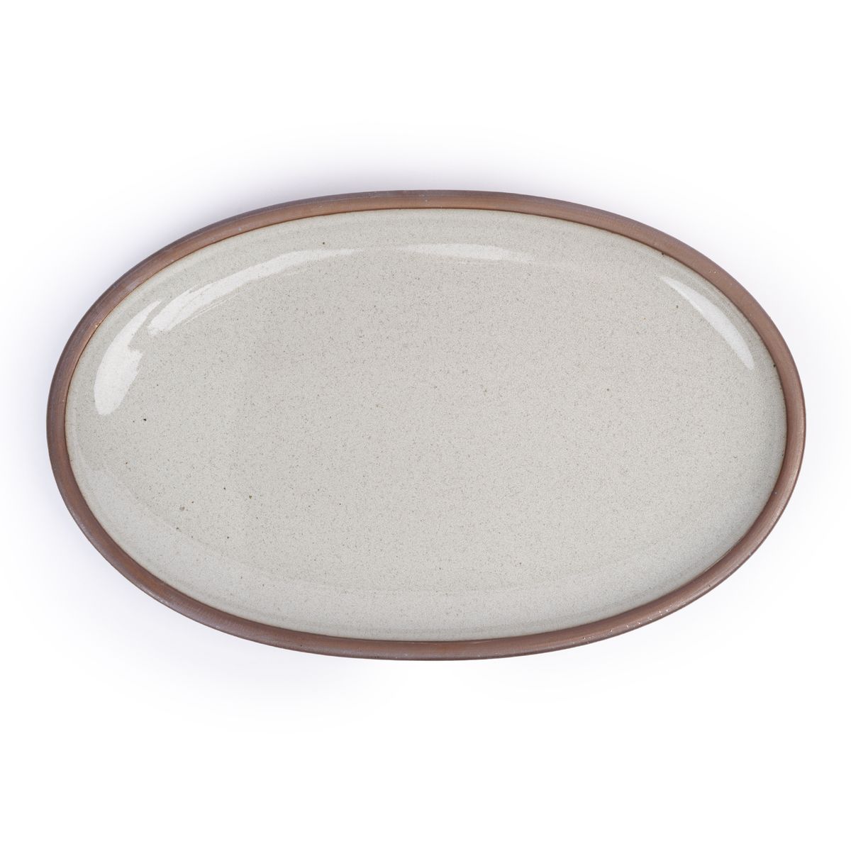 A large oval ceramic platter in a reflective icy off-white color featuring iron speckles and an unglazed rim