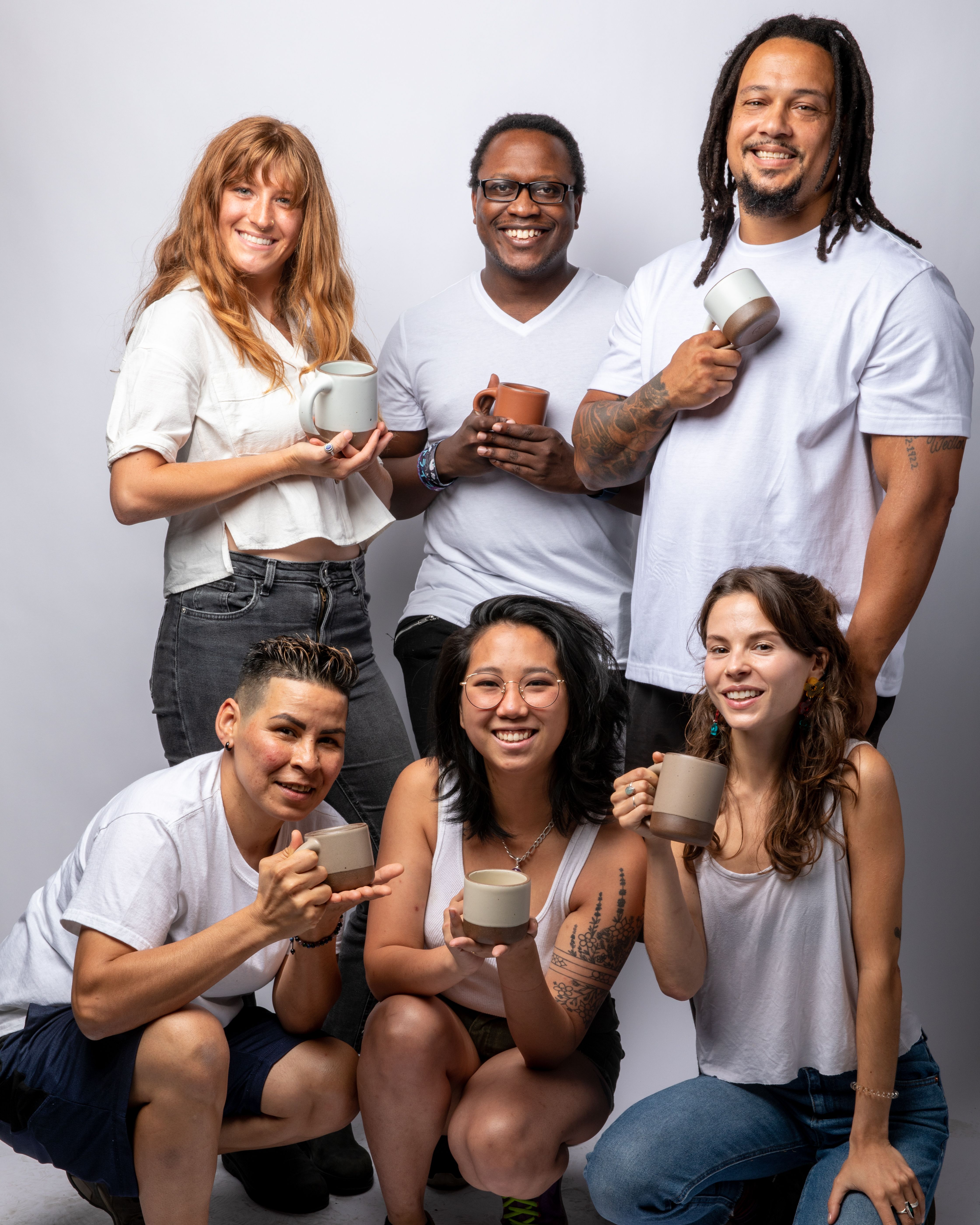 East Fork employees pose with the pottery company's new mugs
