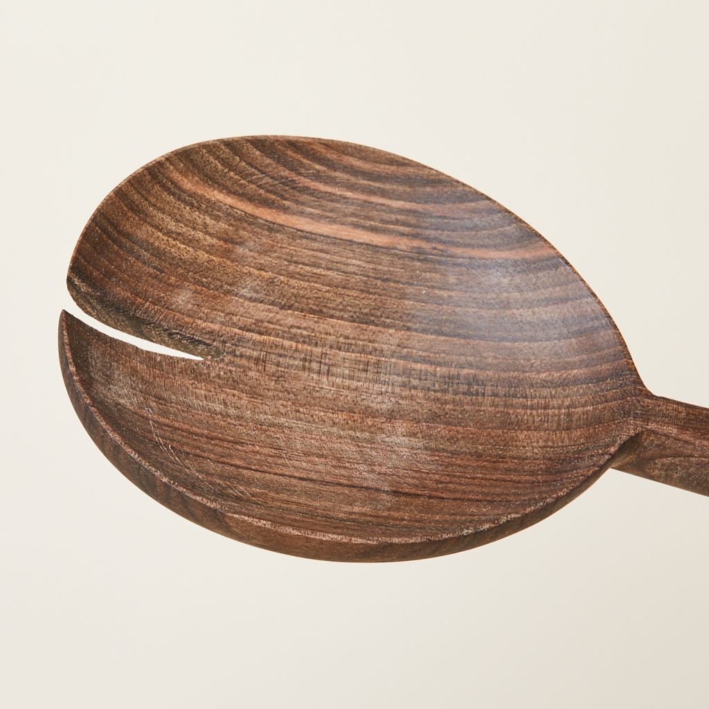 Close-up of the bowl of a walnut serving spoon, showing notch that was removed along with the wood grain