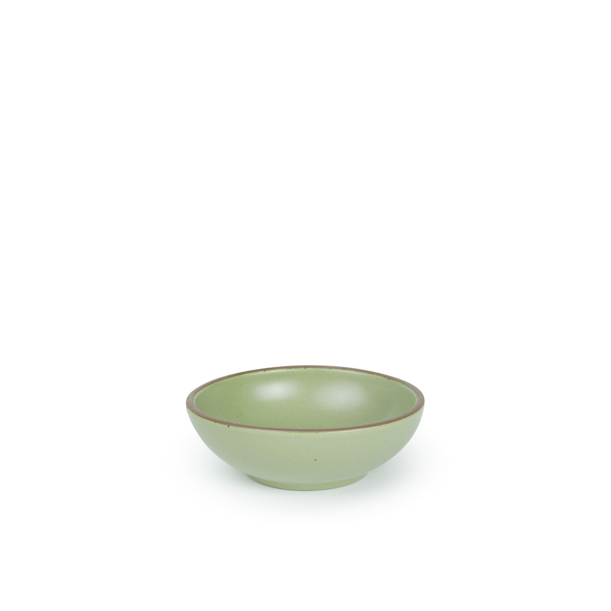 A small shallow ceramic bowl in a calming sage green color featuring iron speckles and an unglazed rim