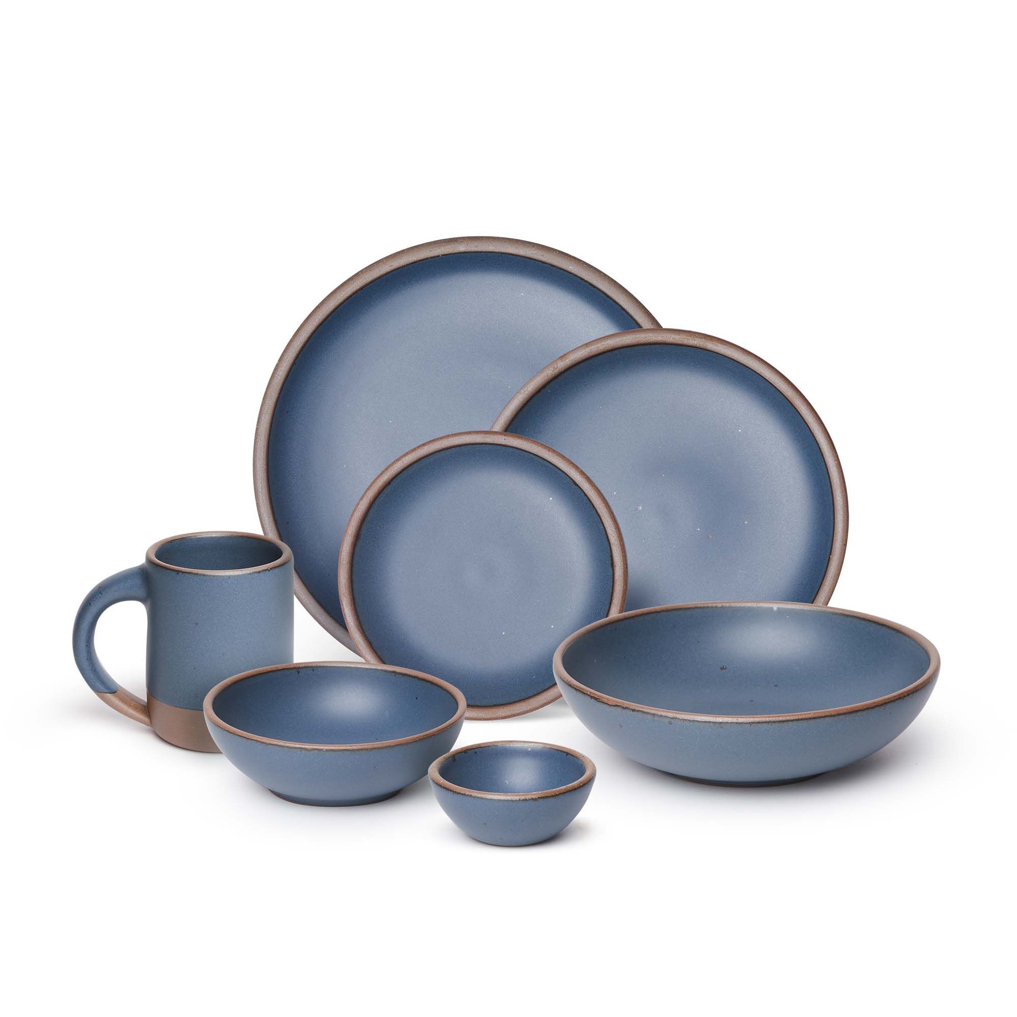 The Mug, bitty bowl, breakfast bowl, everyday bowl, cake plate, side plate and dinner plate paired together in a toned-down navy color featuring iron speckles