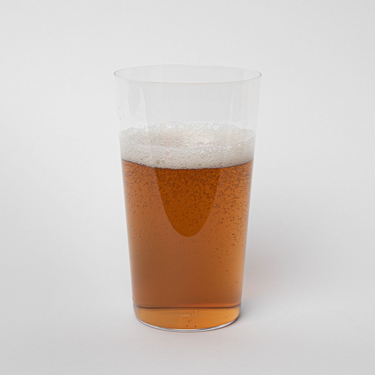 Clear simple beer glass filled with beer