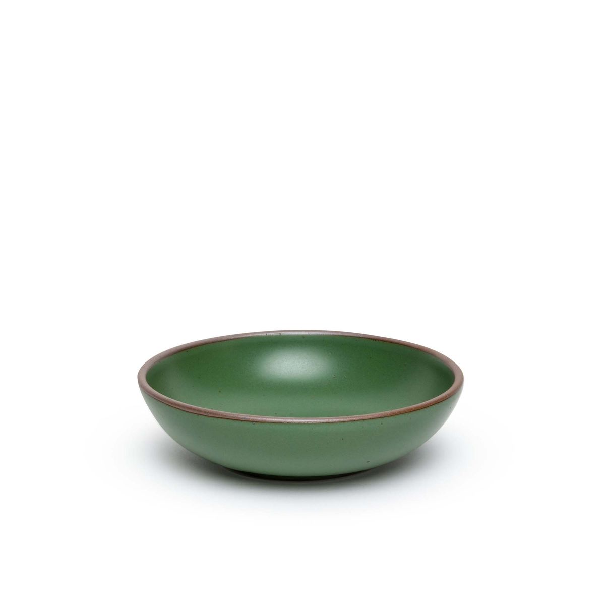 A dinner-sized shallow ceramic bowl in a deep, verdant green color featuring iron speckles and an unglazed rim