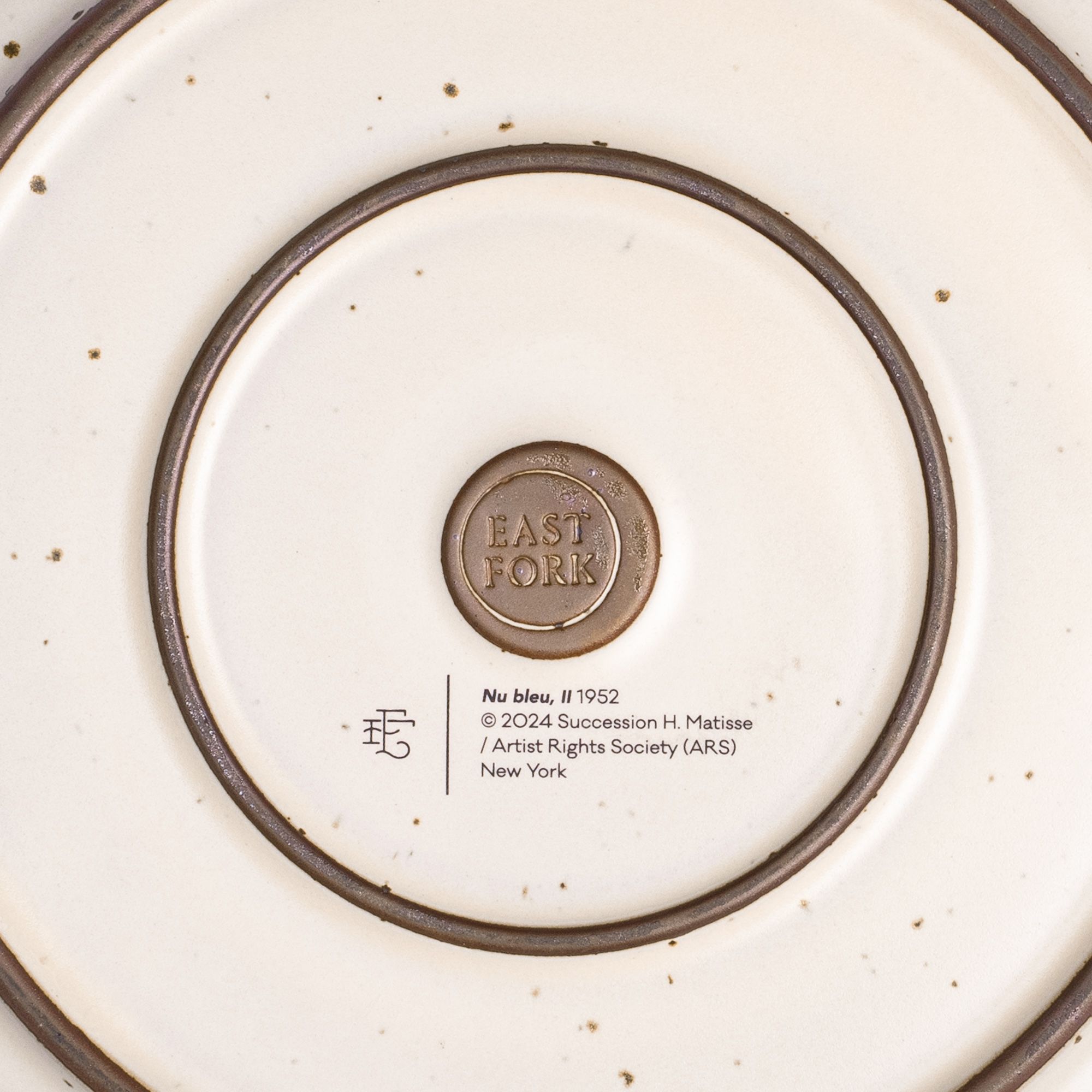 The back of the Dinner Platter with an East Fork stamp with a small decal of information about the artwork.