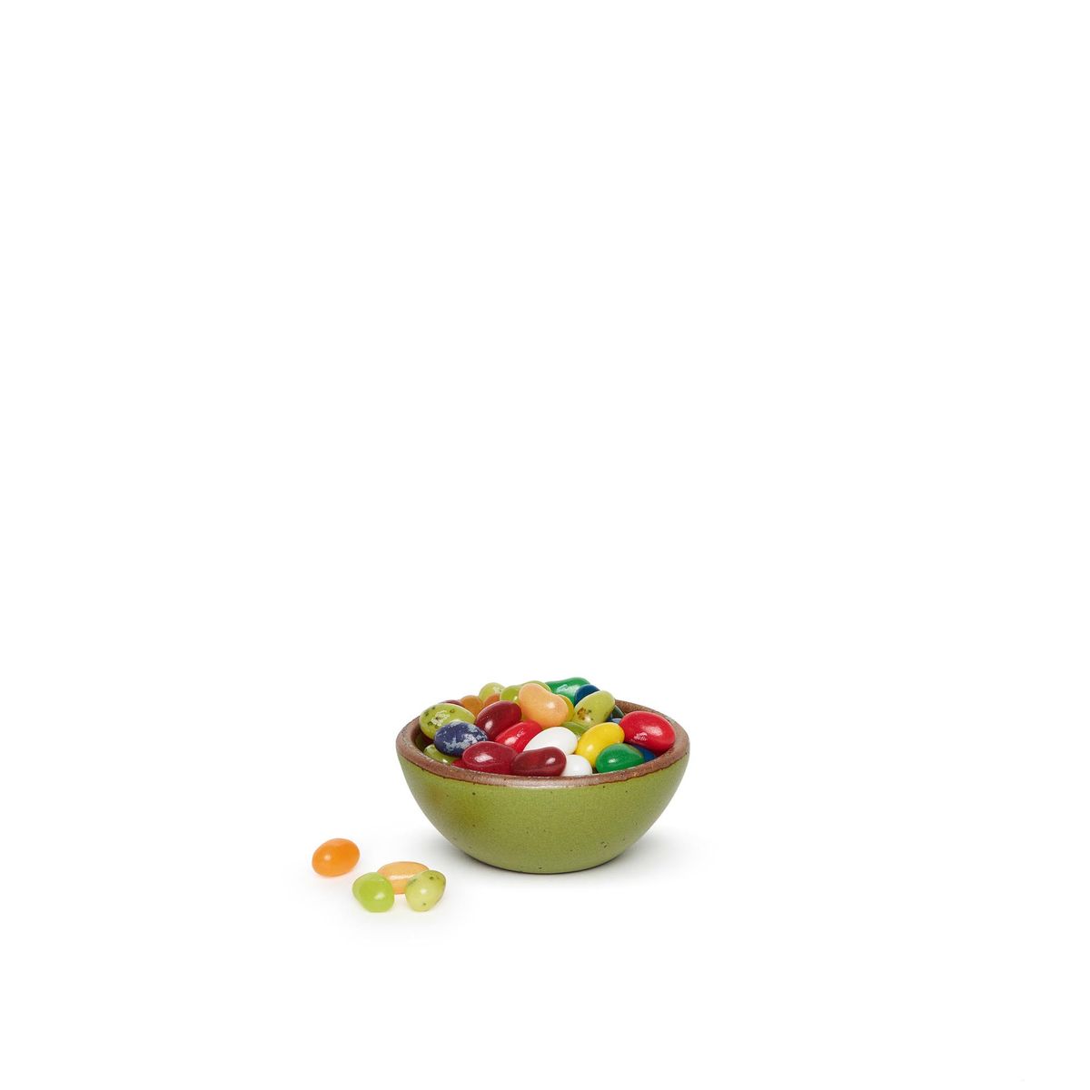A mossy green bowl that could fit in the palm of your hand. Here, it's pictured with a handful of jelly beans.