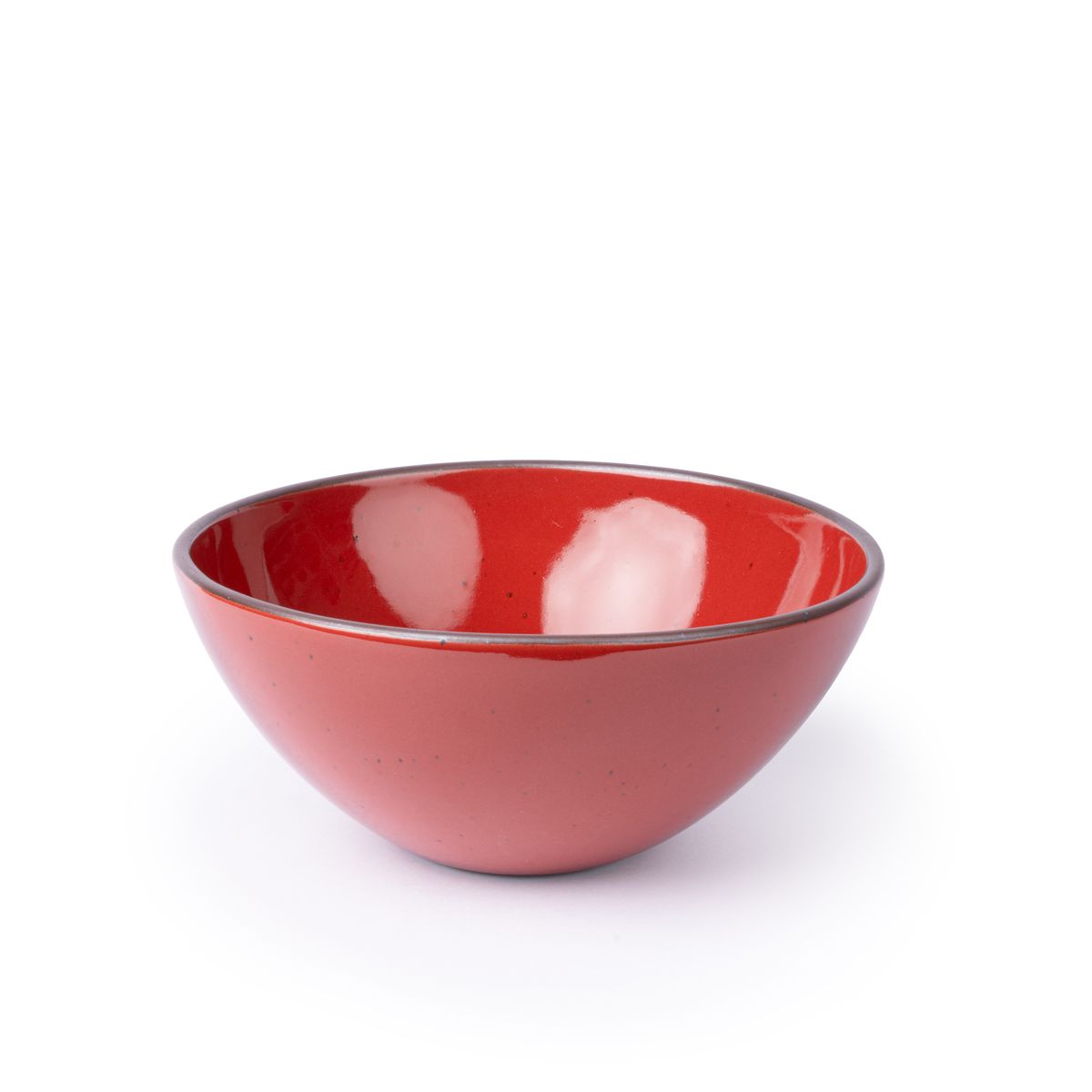 A large rounded ceramic bowl in a glossy red color featuring iron speckles and an unglazed rim