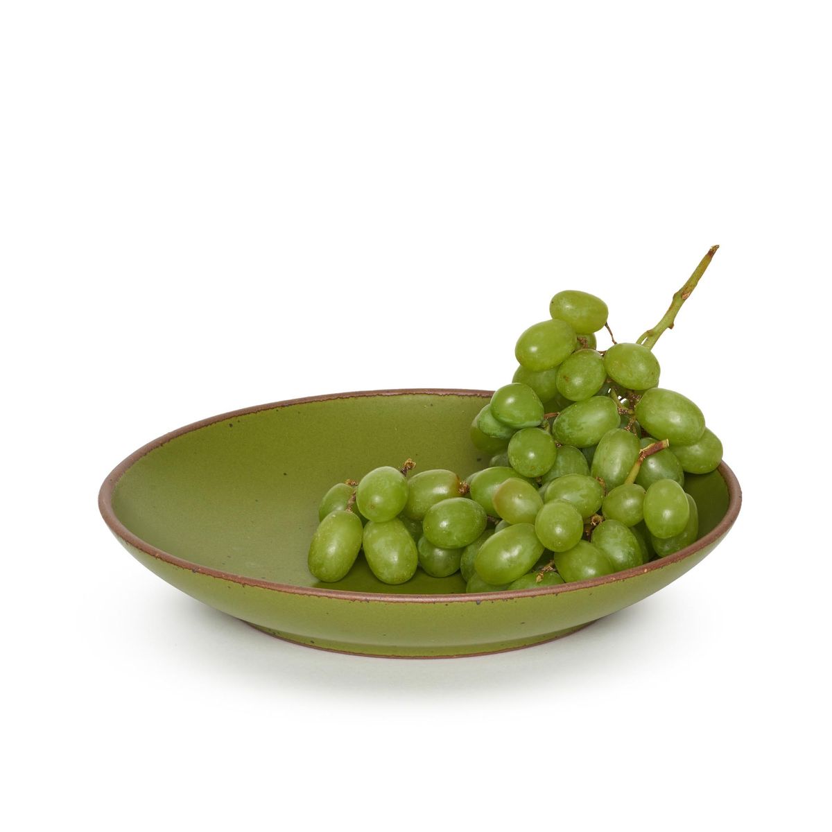 The Coupe in Fiddlehead, a mossy, olive green. Pictured with a bunch of green grapes.