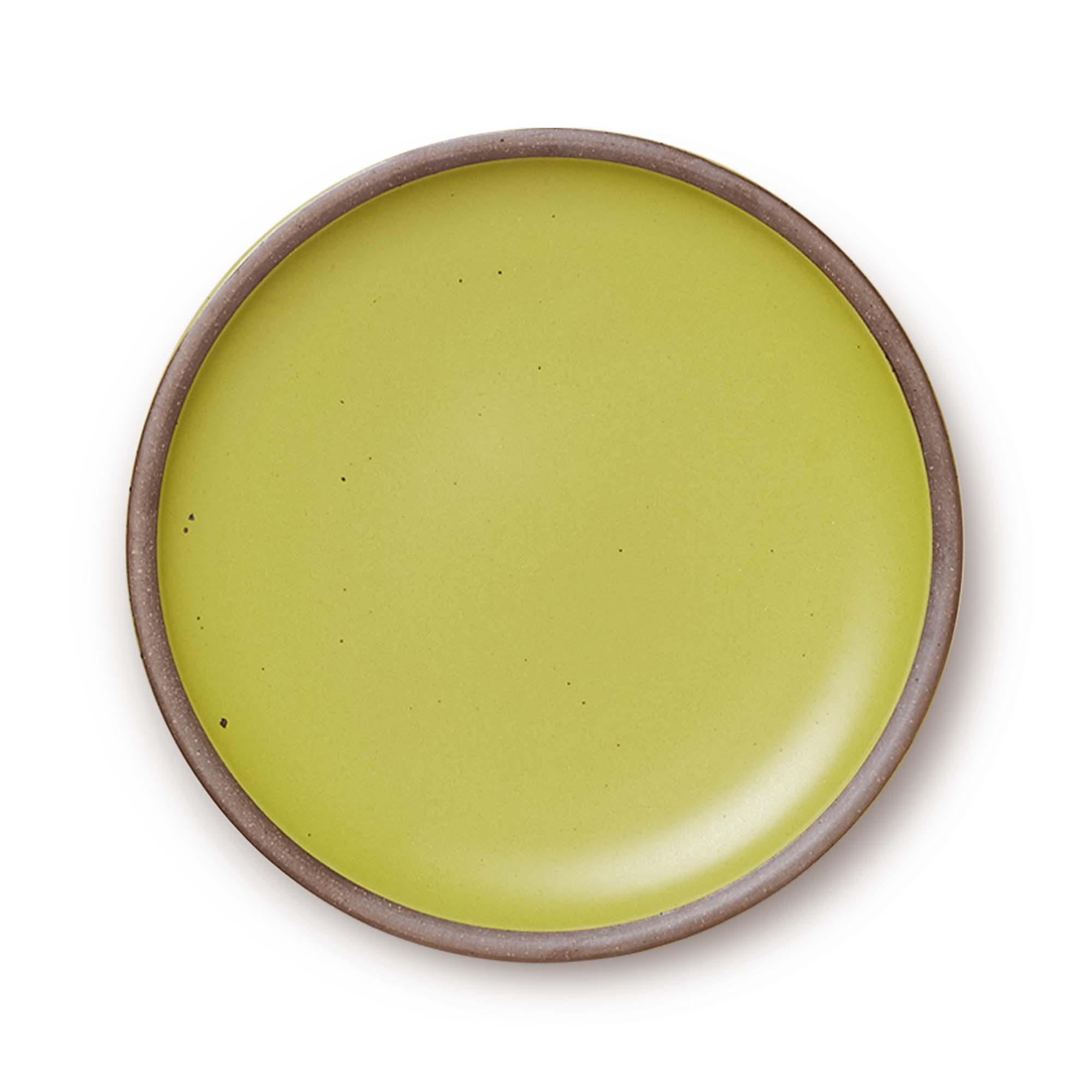 A large ceramic platter in a warm light green color featuring iron speckles and an unglazed rim.