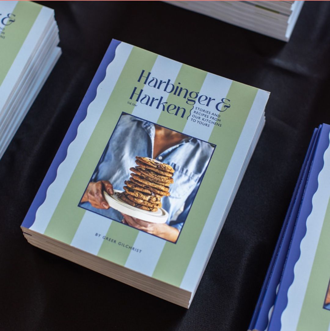 A cookbook cover featuring a photo of stack of cookies titled 'Harbinger & Harken'