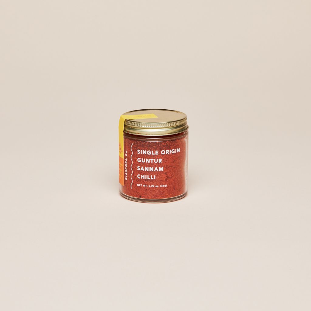 Gold lid on a glass jar filled with red chilli powder