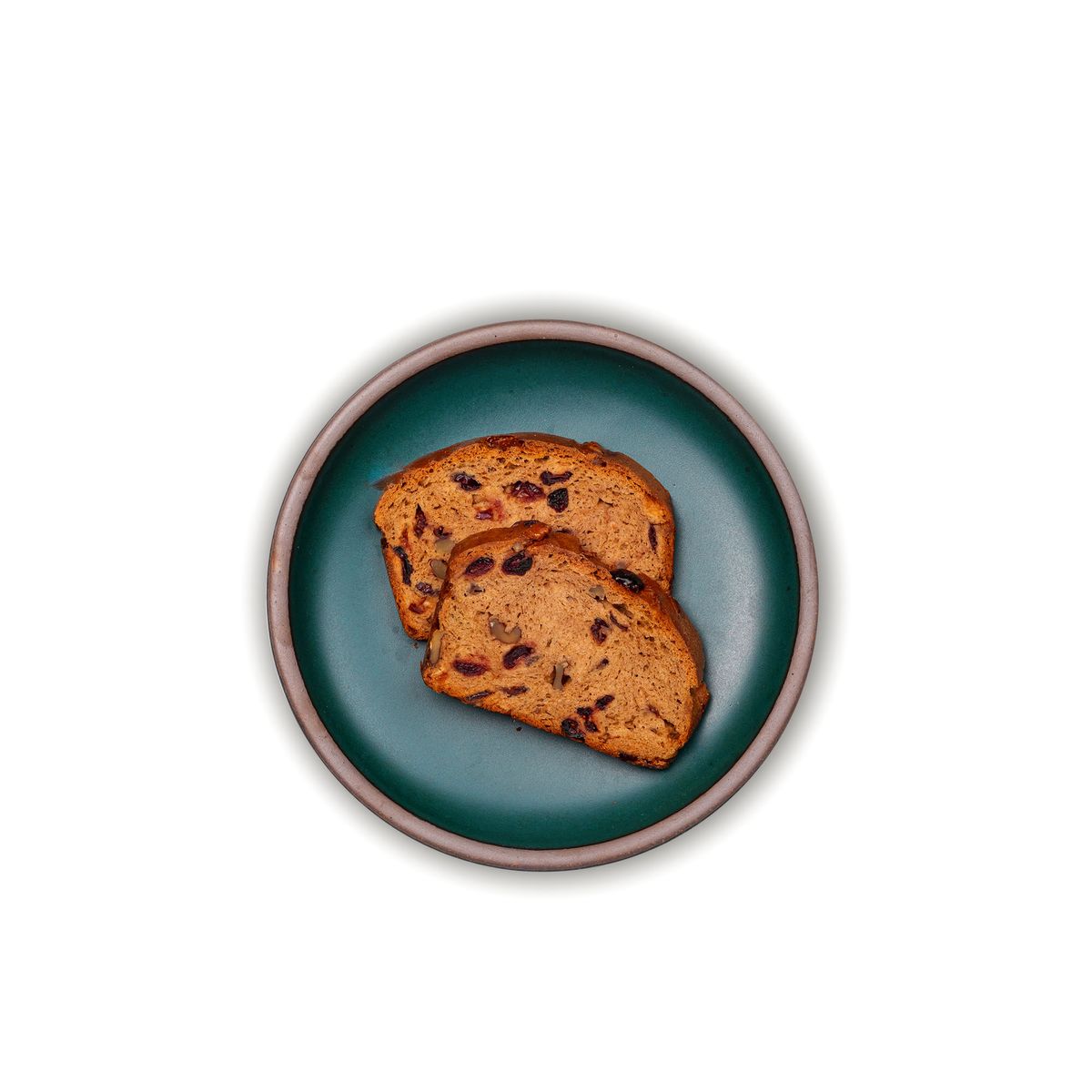 Two raisin bread slices on a medium sized ceramic plate in a deep dark teal color featuring iron speckles and an unglazed rim.