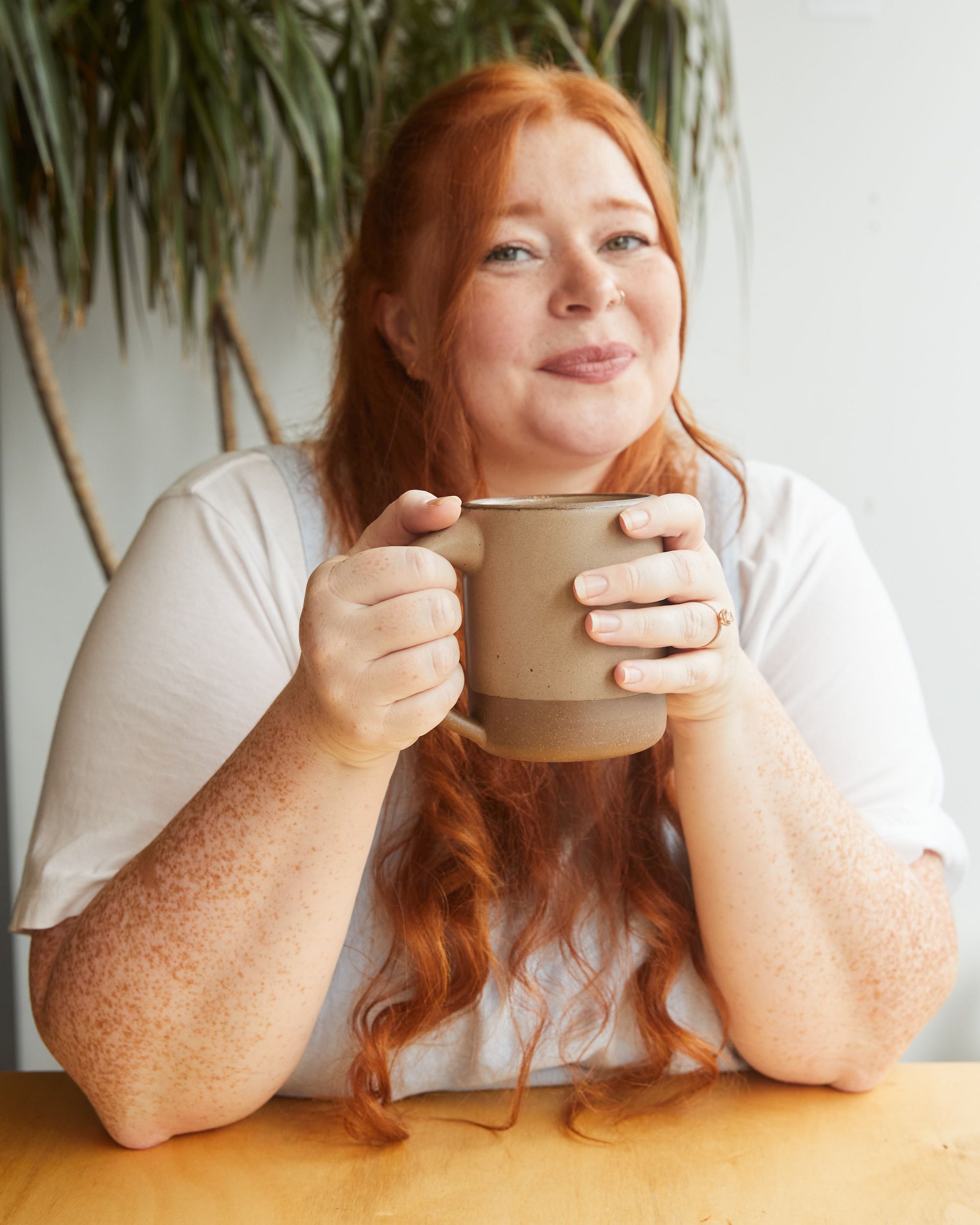 Sarajane Case holding The Big Mug in Morel and smiling at the camera