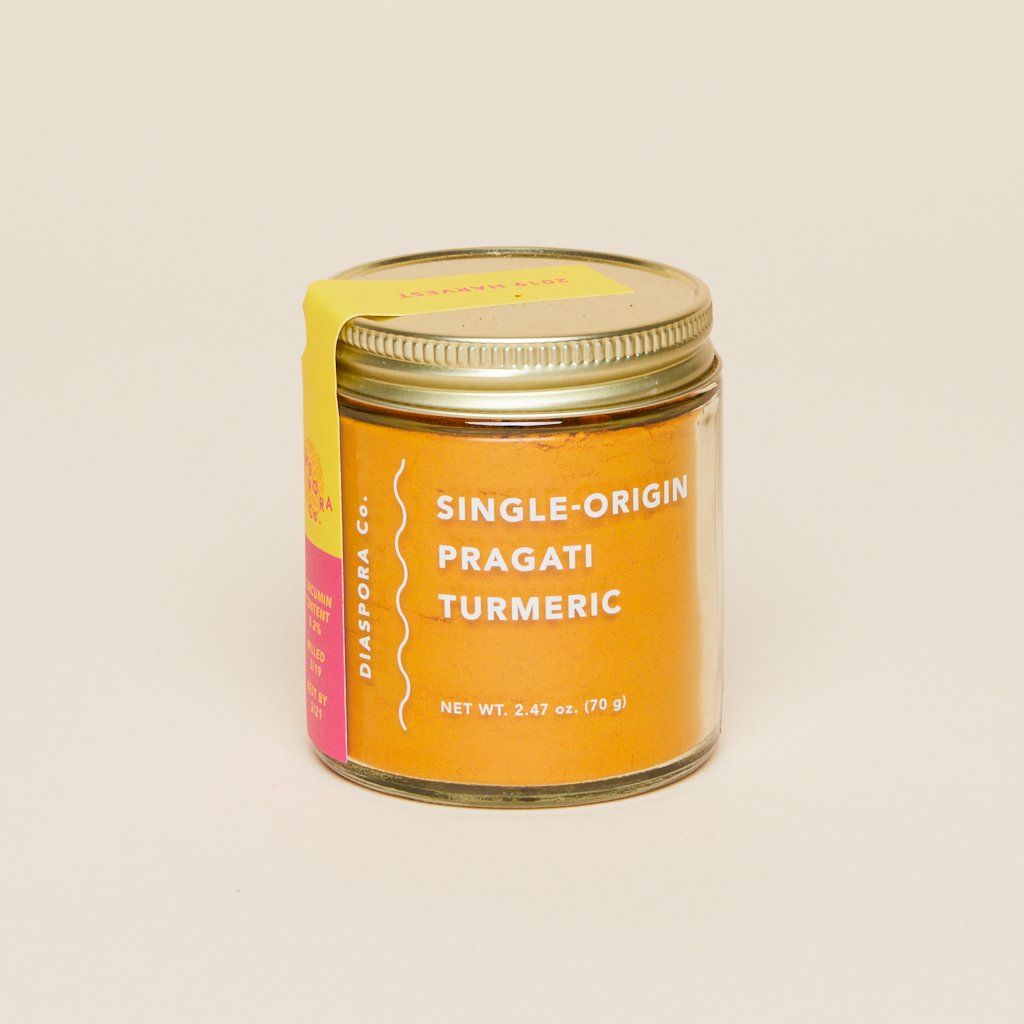 Glass jar full of single-origin Pragati turmeric