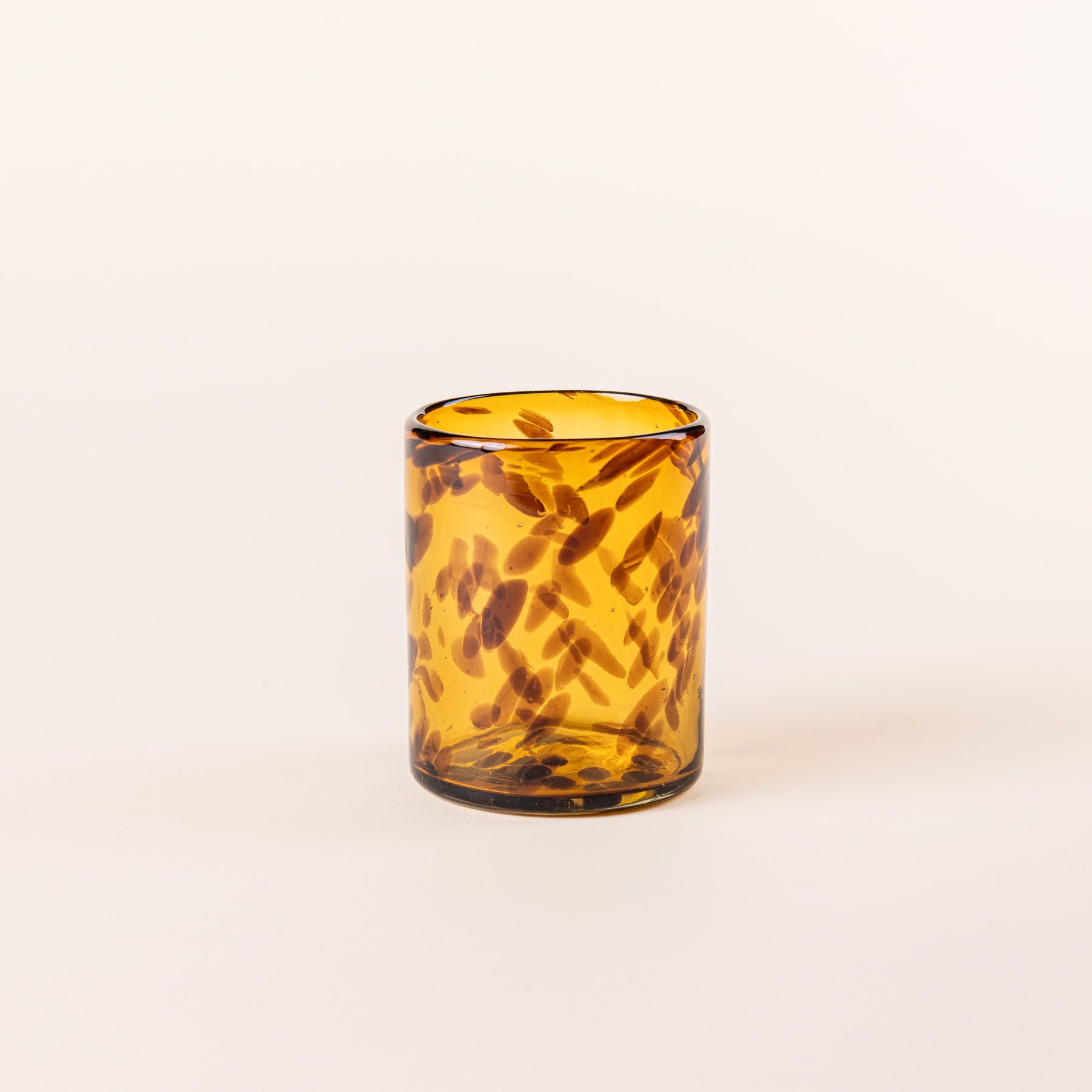 A short tortoiseshell drinking glass