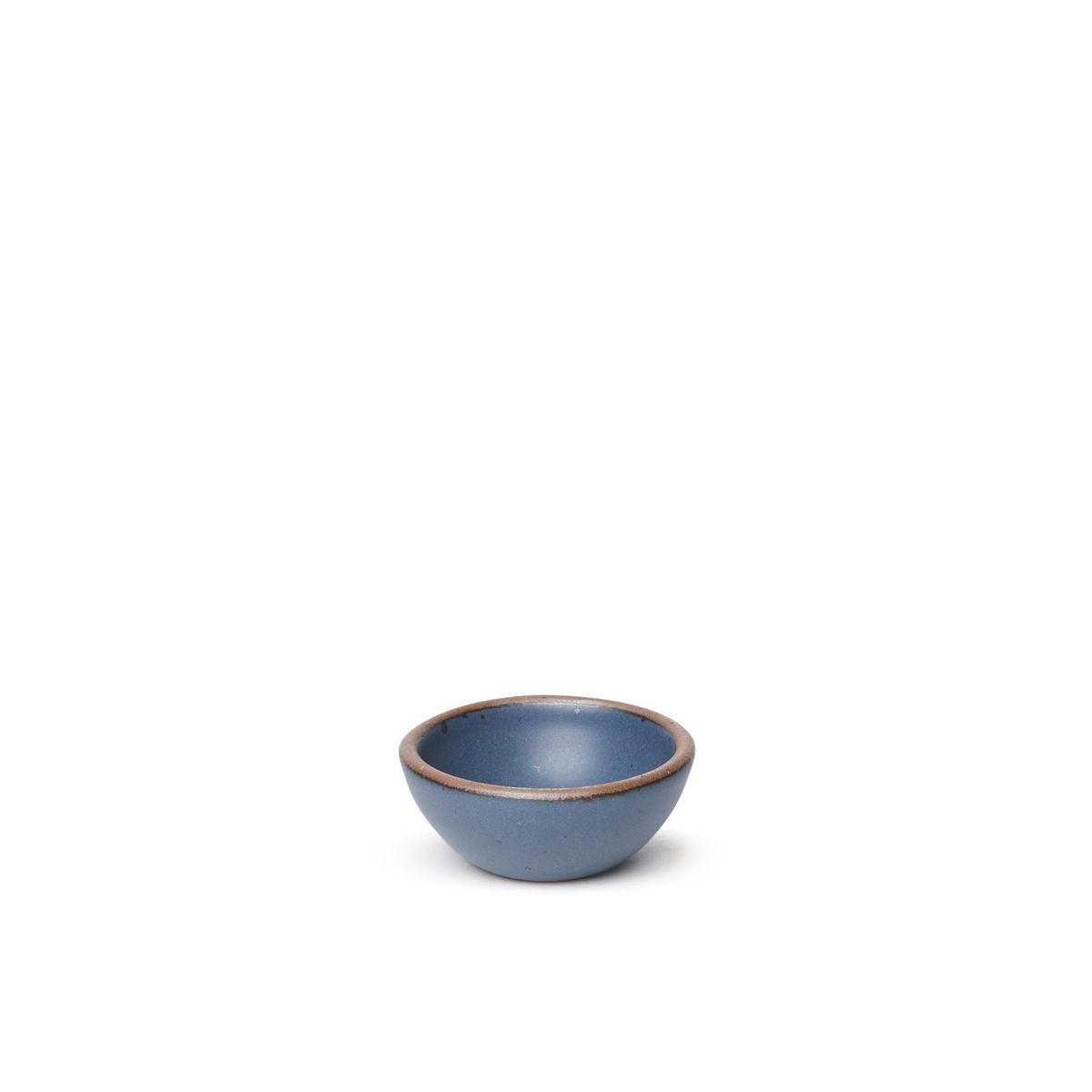 A tiny rounded ceramic bowl in a toned-down navy color featuring iron speckles and an unglazed rim