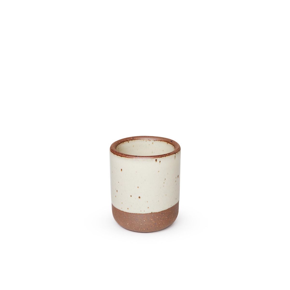 A small, short ceramic mug cup in a warm, tan-toned, off-white color featuring iron speckles and unglazed rim and bottom base.