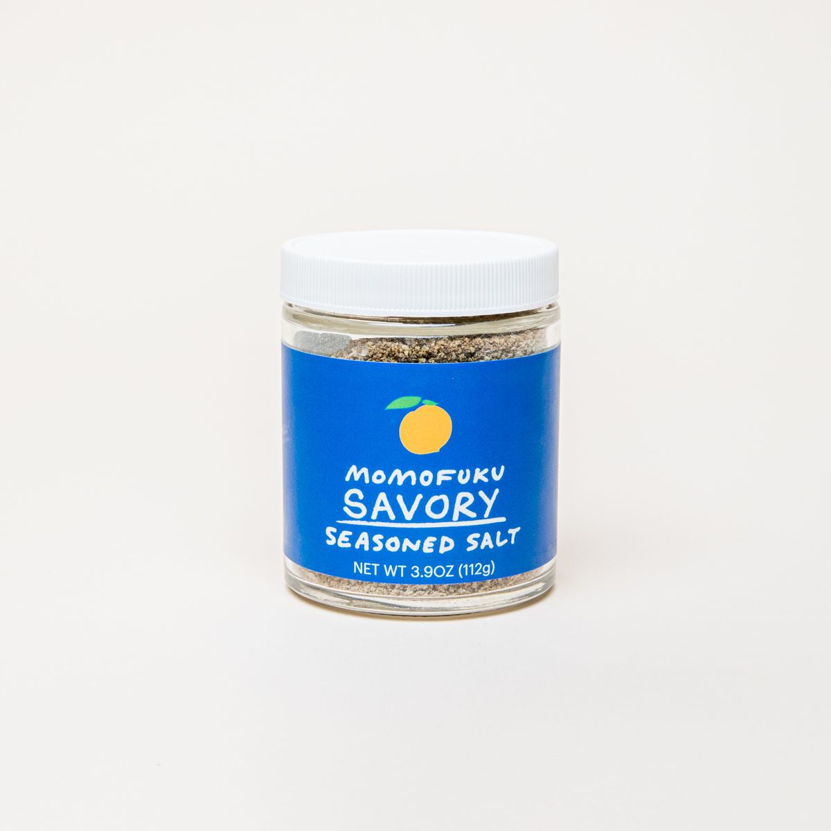A jar with a white top and blue label that reads "Momofuku Savory Seasoned Salt"