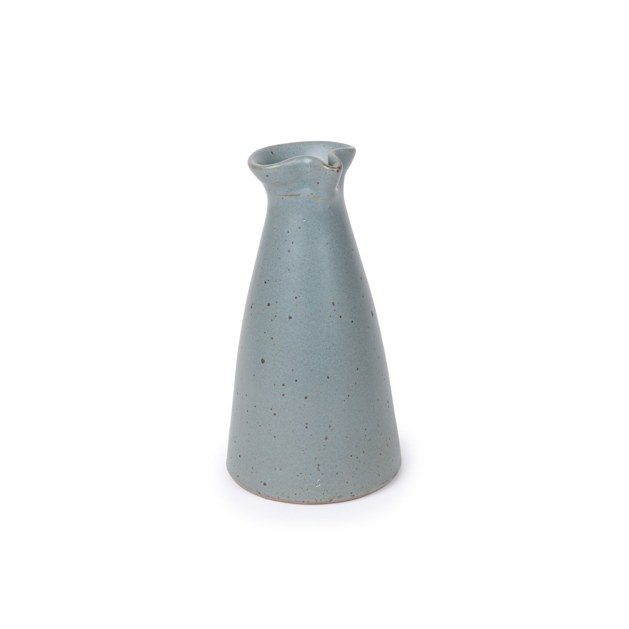 A small ceramic creamer with a narrow body and a subtle pouring spout at the top, in a blue-grey color, at an angle.