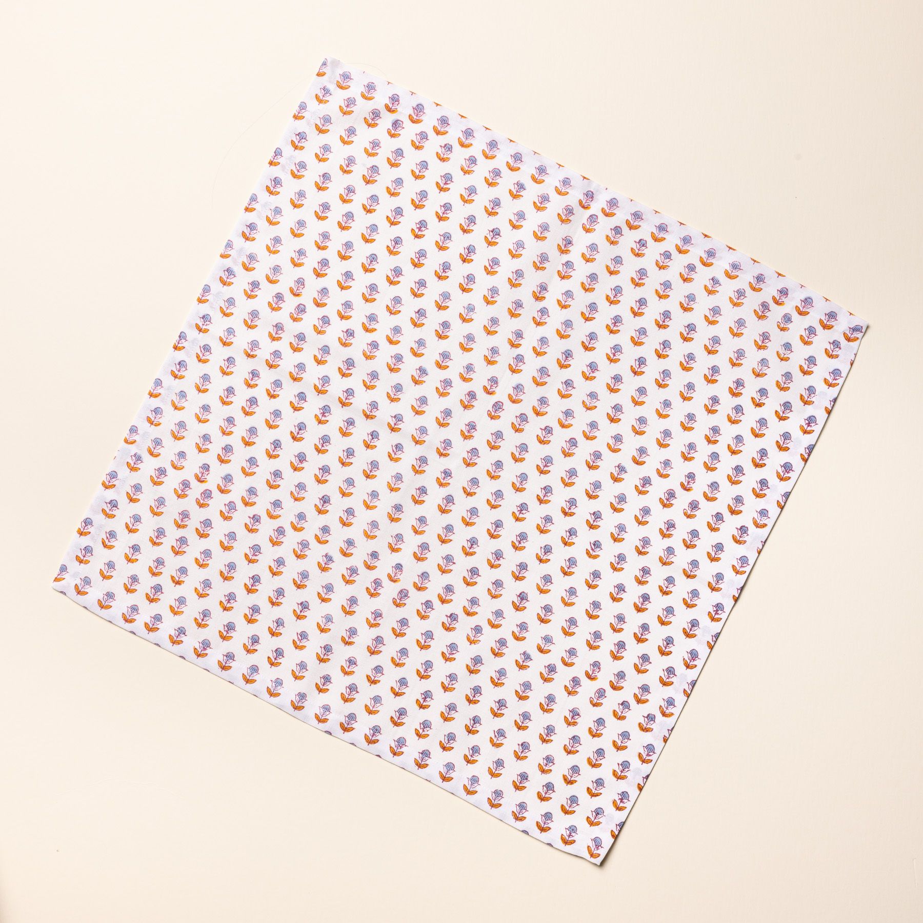 1 unfolded square dinner napkins with a pink and purple small floral pattern against a white background design