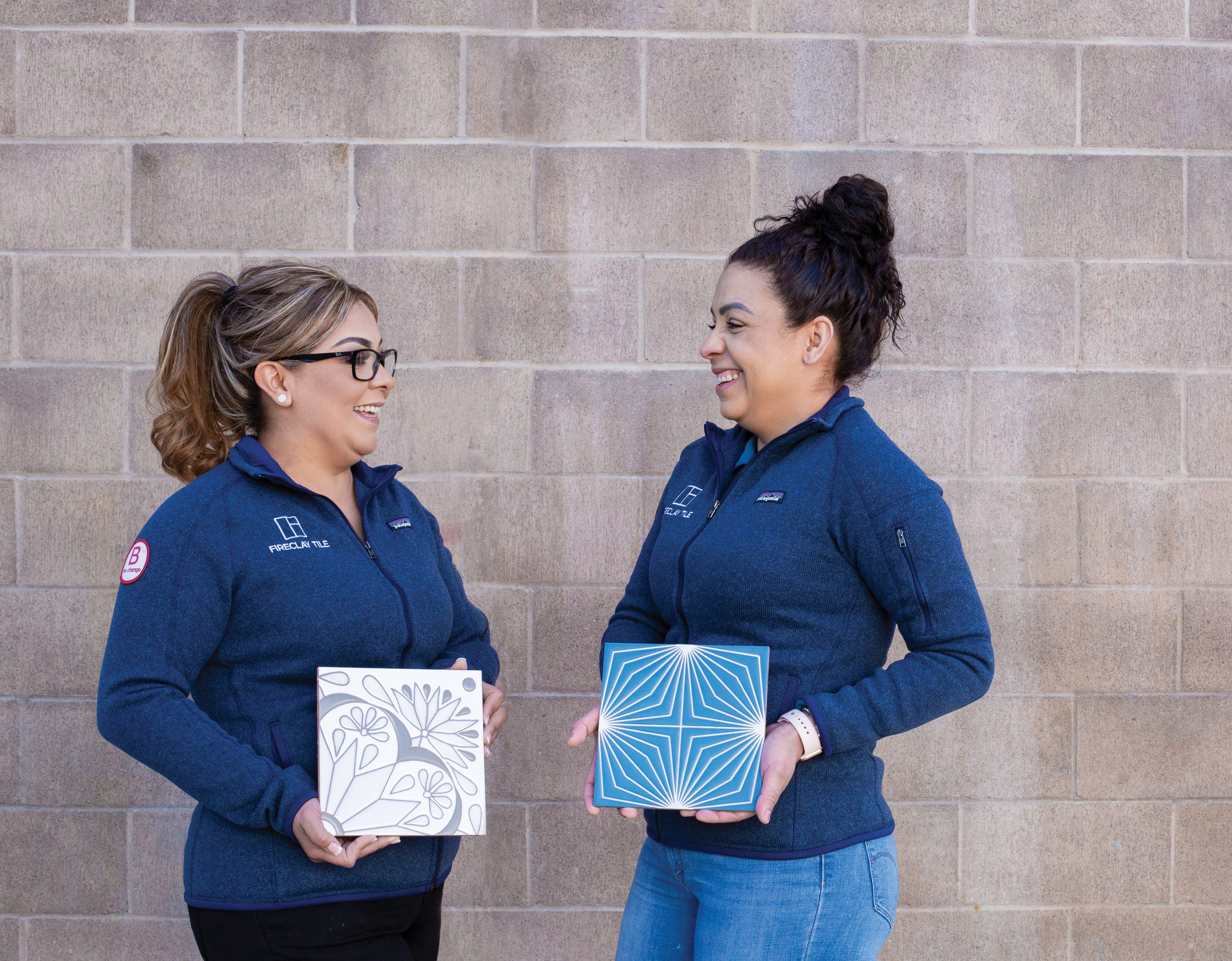 Fireclay Tile employees holding sets