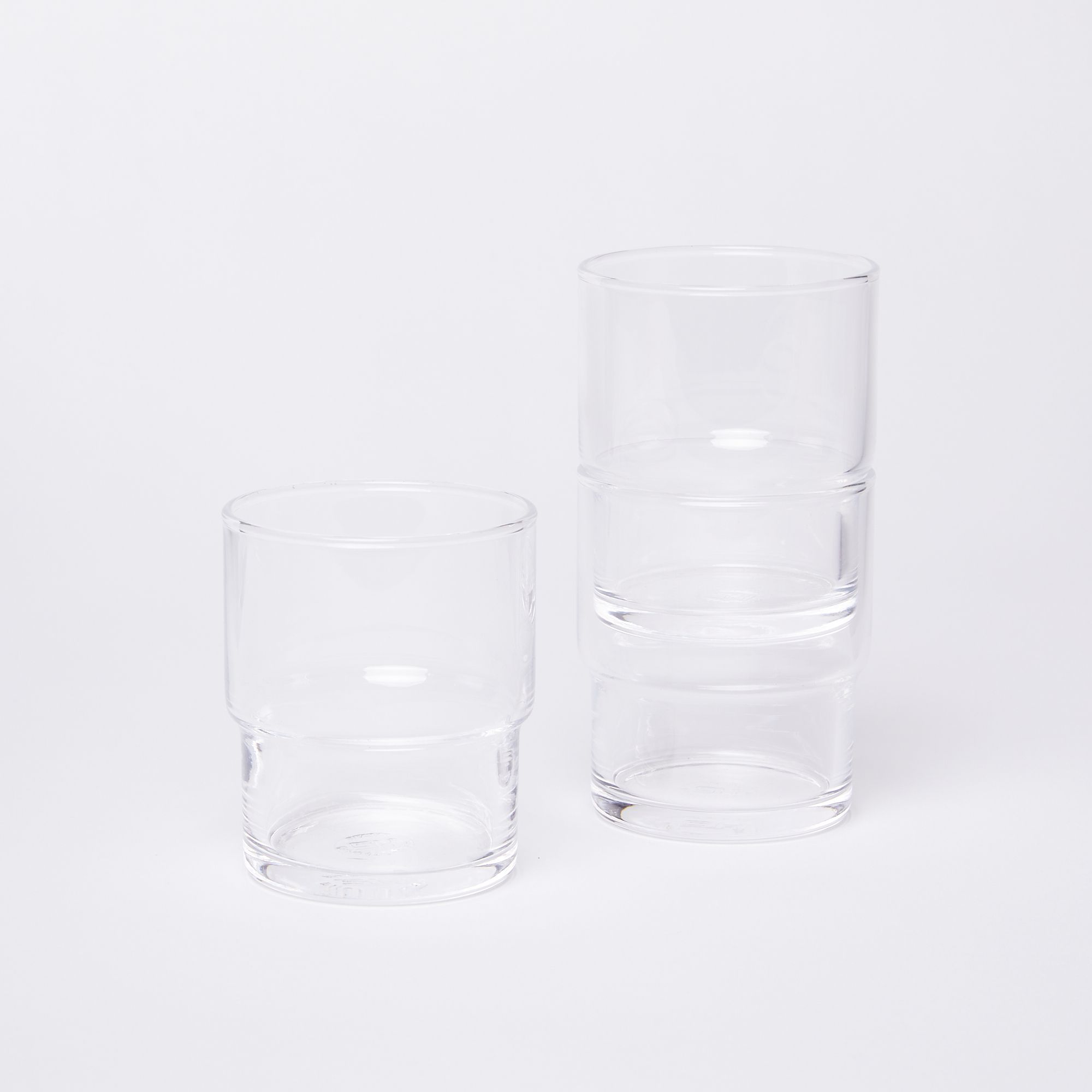 One glass on the left next to two stacked glasses on the right