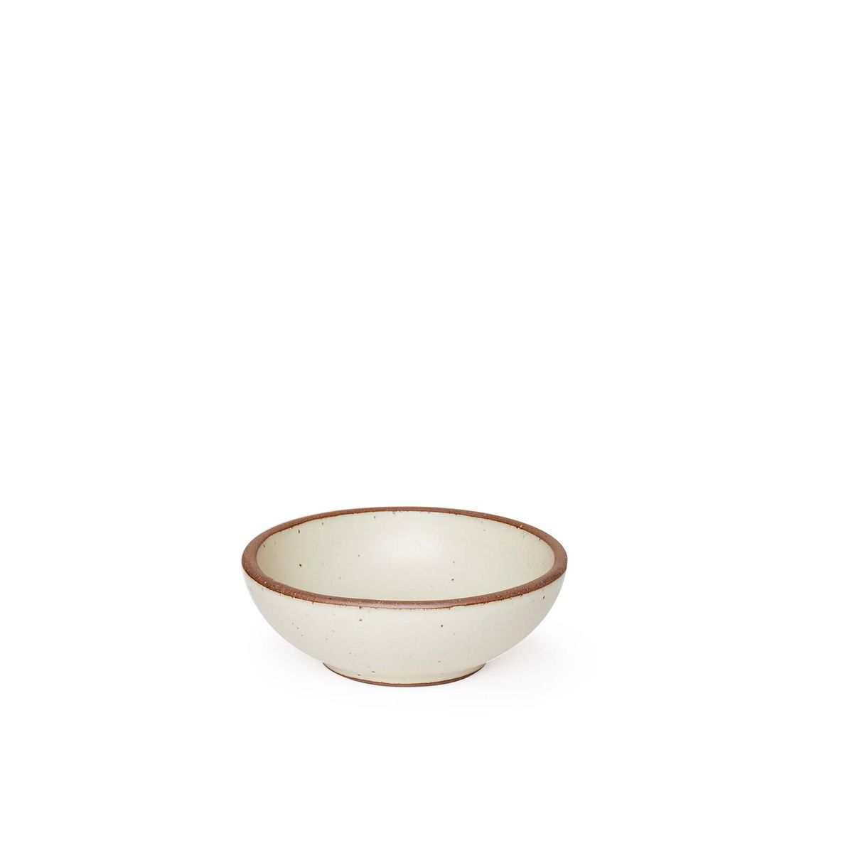 A small shallow ceramic bowl in a warm, tan-toned, off-white color featuring iron speckles and an unglazed rim