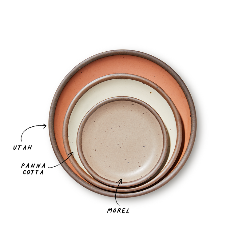 A stack of 3 plates in Dinner, Side, and Cake sizes in a peach, warm off-white, and warm pale brown colors.