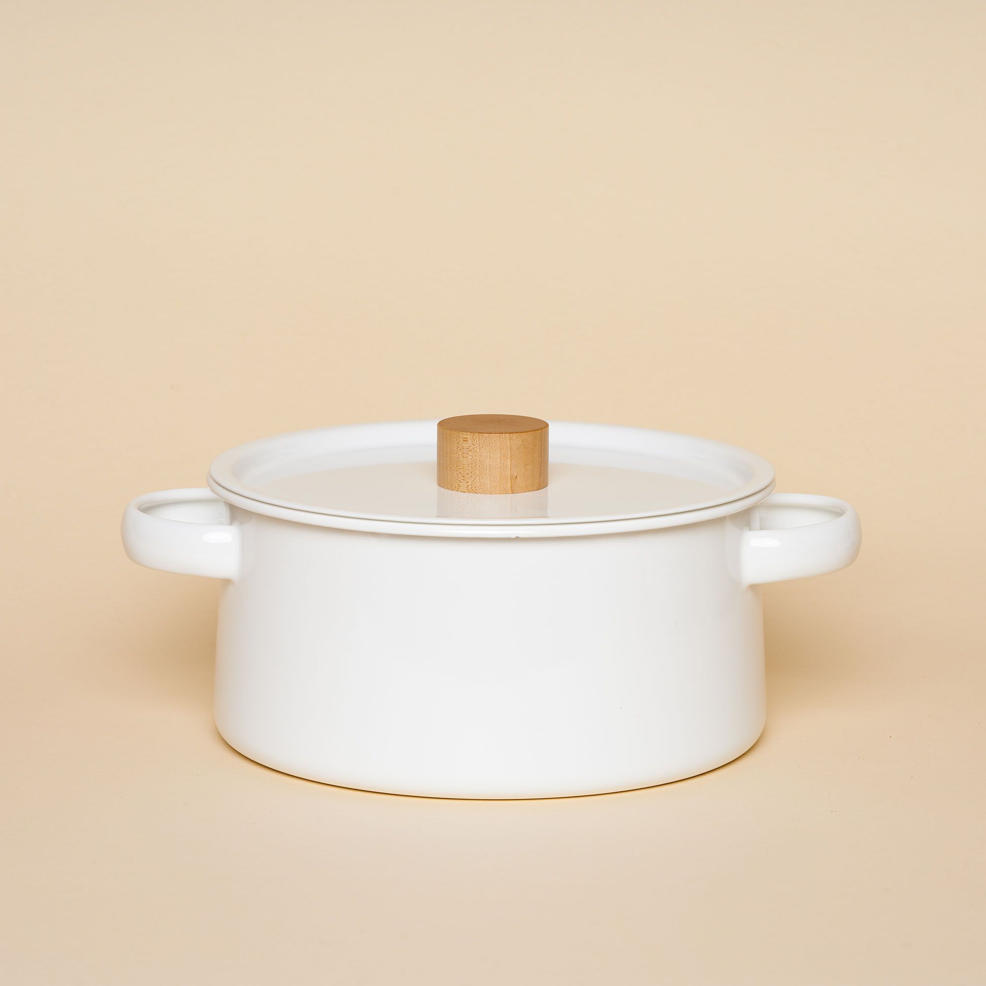 A white enamel pot with a tapered shape, handles on the side and light wooden handle on top.