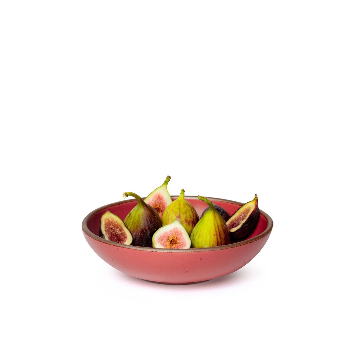 Figs in a dinner-sized shallow ceramic bowl in a bold red color featuring iron speckles and an unglazed rim