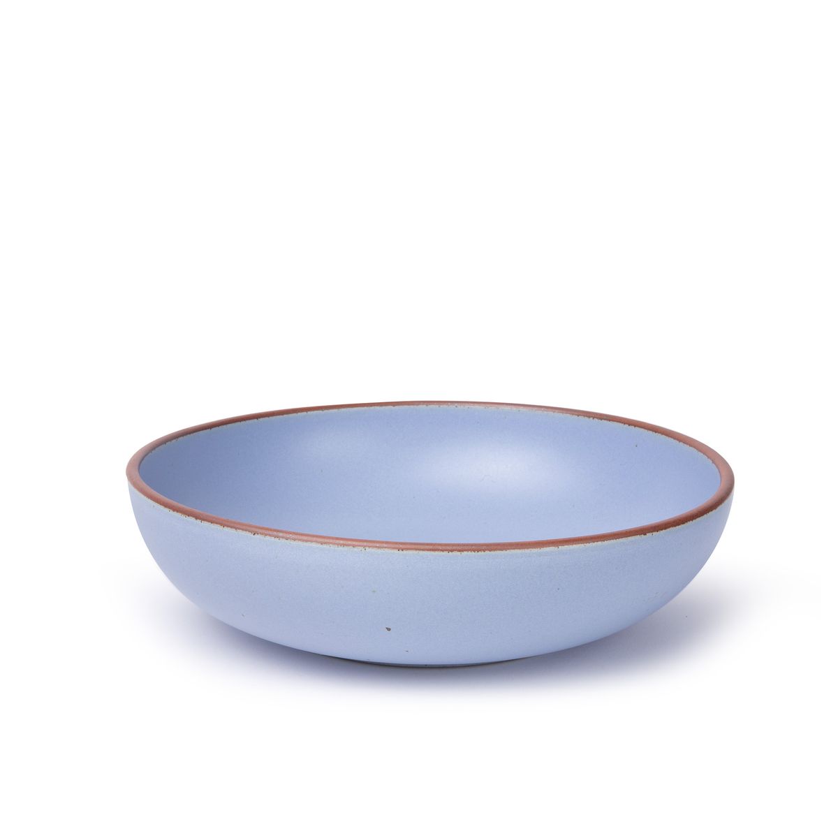 A large shallow serving ceramic bowl in a periwinkle color featuring iron speckles and an unglazed rim.