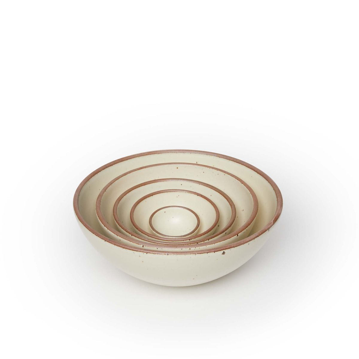 A bitty bowl, ice cream bowl, soup bowl, popcorn bowl, and mixing bowl nesting together in a warm, tan-toned, off-white color featuring iron speckles