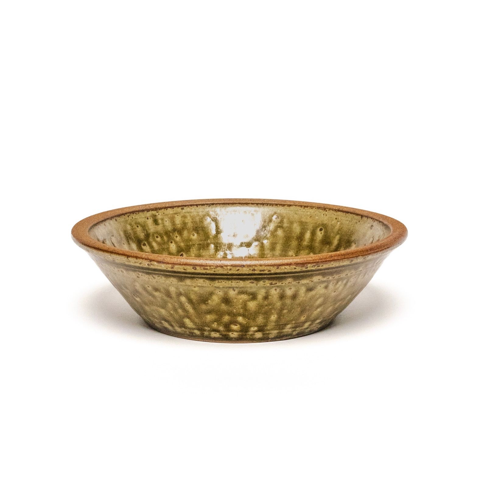 A short angular ceramic bowl in an earthy green and brown color with a slightly wide unglazed rim