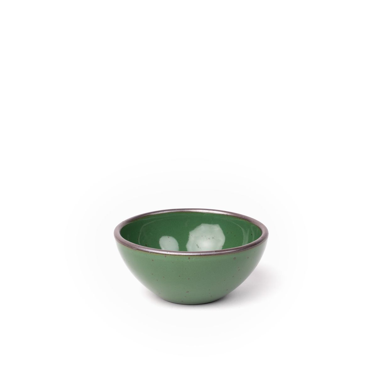 A small dessert sized rounded ceramic bowl in a glossy emerald green color featuring iron speckles and an unglazed rim