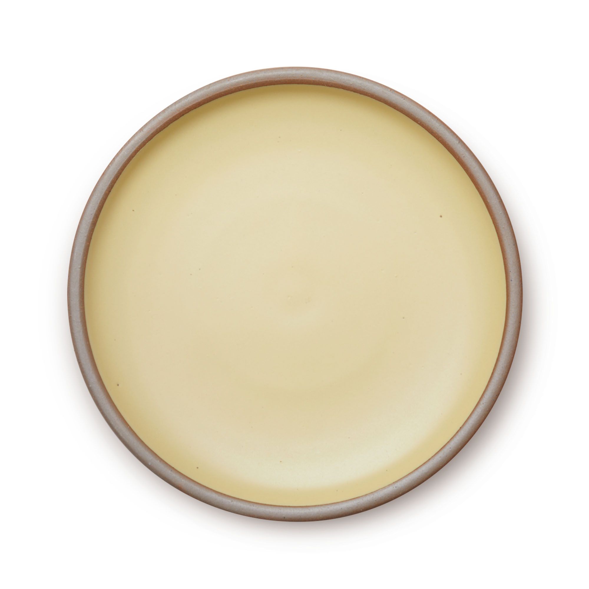 A large ceramic platter in a light butter yellow color featuring an unglazed rim.
