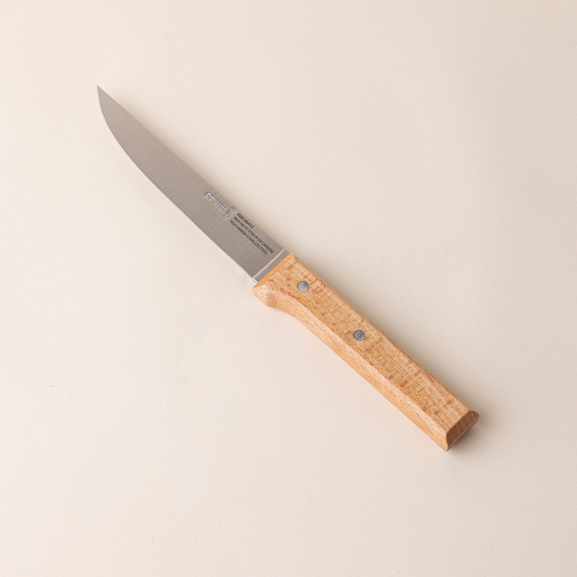 A carving knife with a stainless steel blade and wooden handle