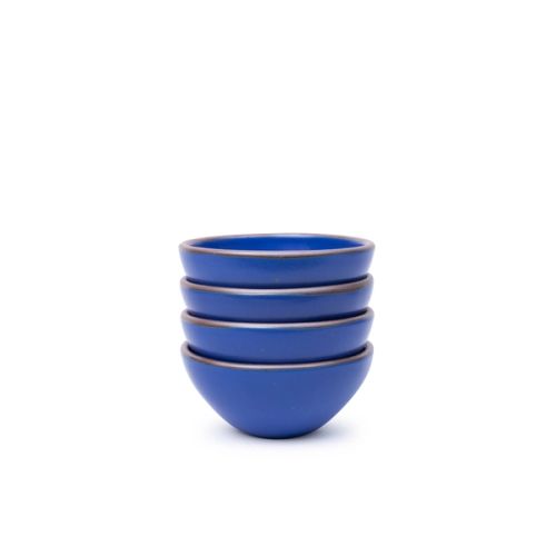 A stack of 4 small dessert sized rounded ceramic bowls in a cobalt blue color featuring iron speckles and an unglazed rim