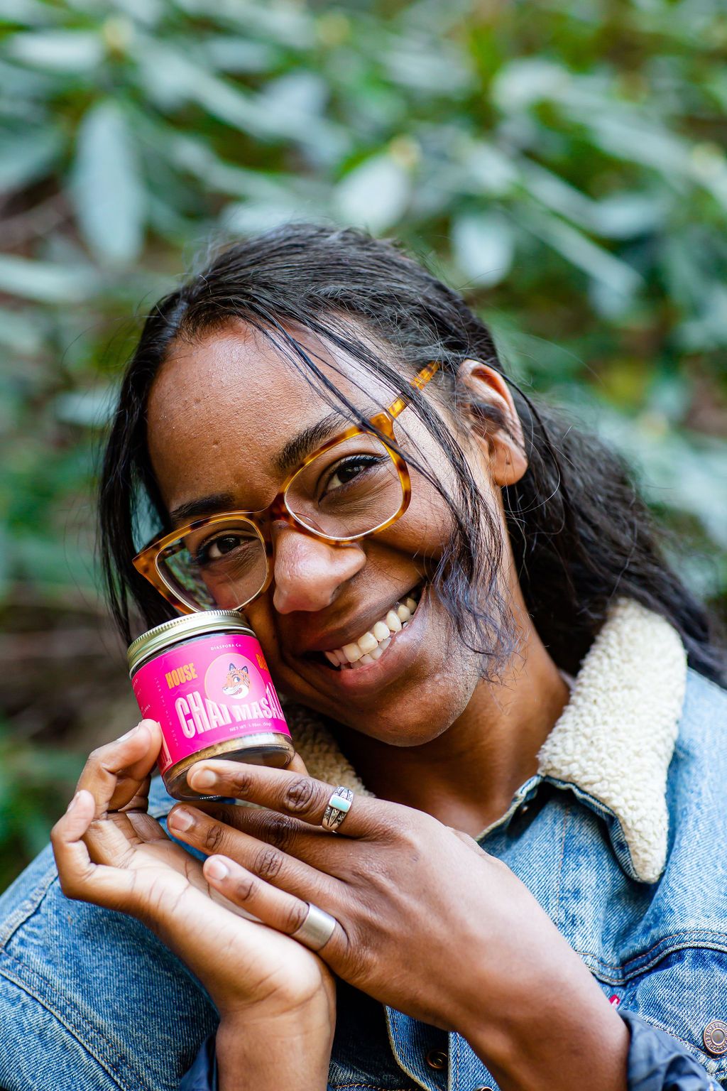 East Fork's Jasmine Michel holds up a glass tin with a bright pink label on it that reads Chai Masala