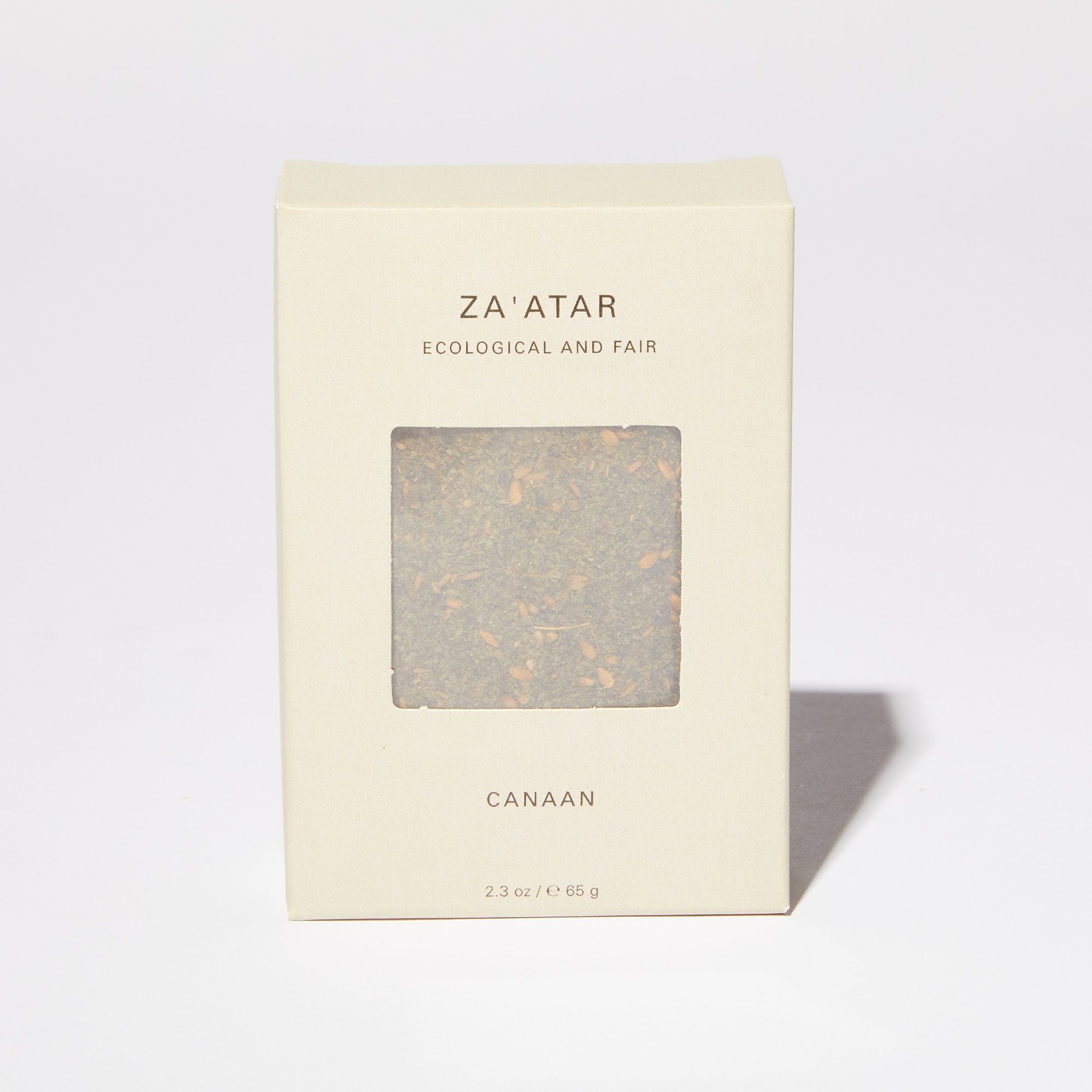 Cream box that reads "Za'atar" "Ecological and Fair" with a translucent panel revealing a green spice mix