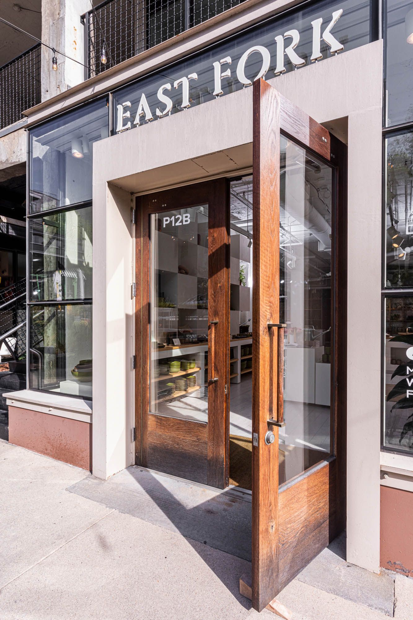 The exterior storefront the East Fork Atlanta store with large wood doors with large windows