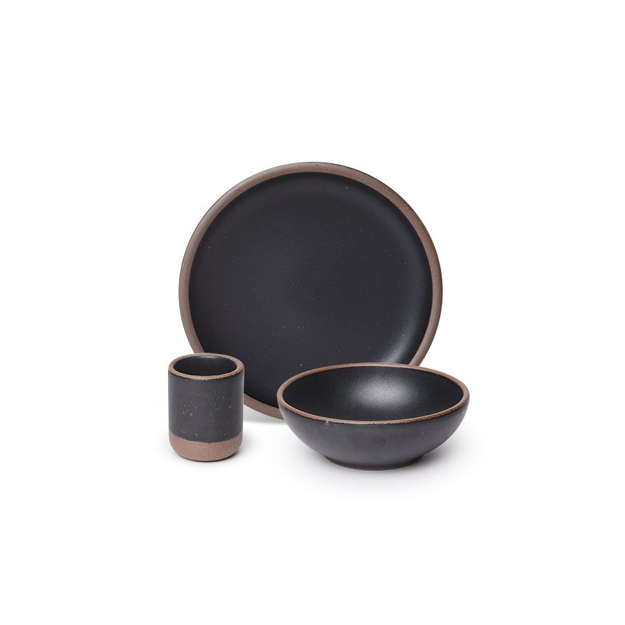 A small tiny cup, a medium sized plate, and a small breakfast bowl paired together in a graphite black color featuring iron speckles.