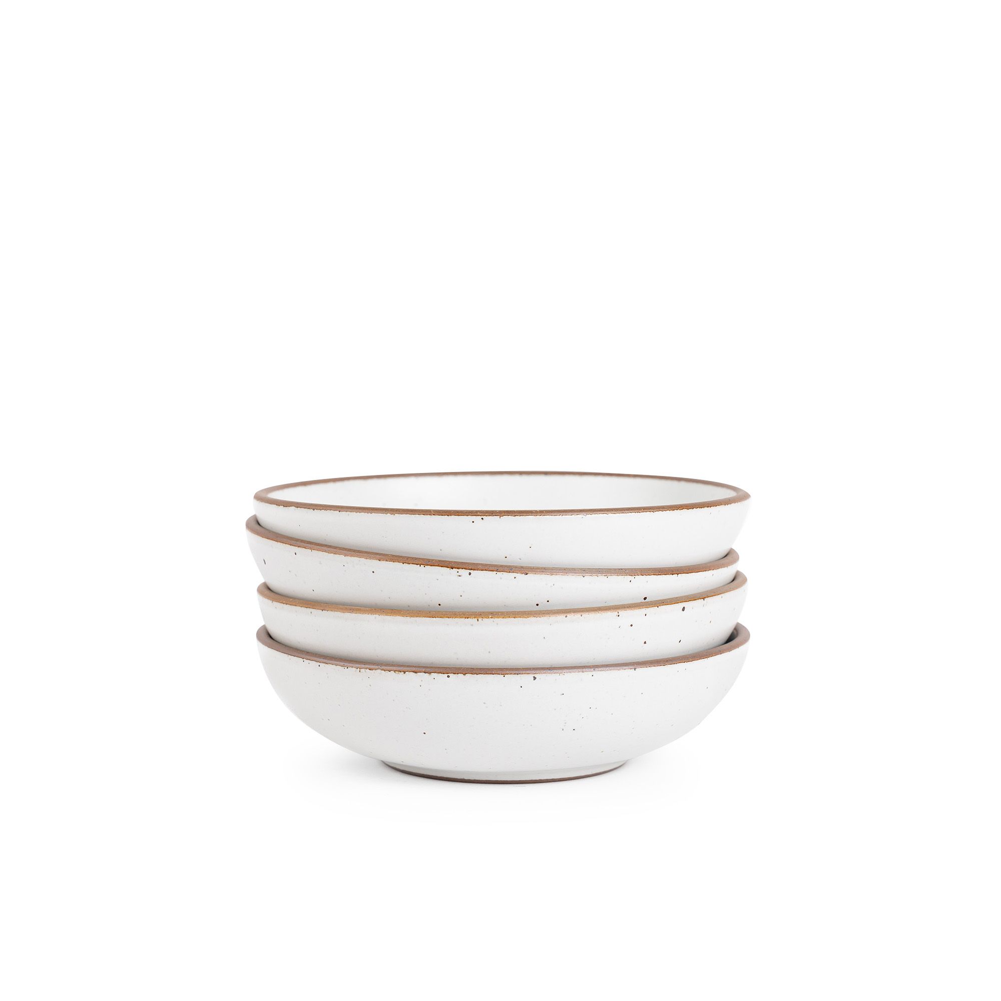 A stack of 4 dinner-sized shallow ceramic bowls in a cool white color featuring iron speckles and an unglazed rim