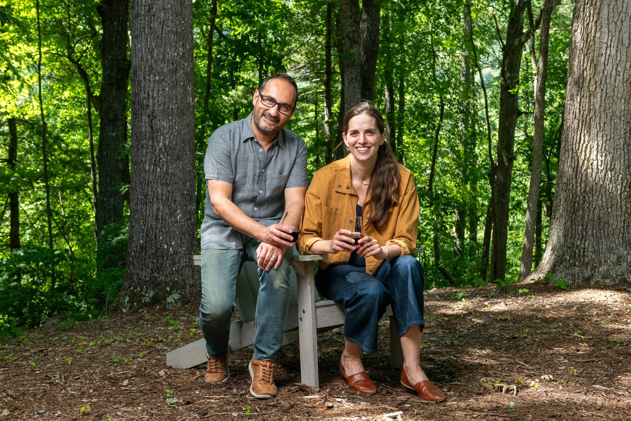 Katie and Felix sitting with a forest backdrop