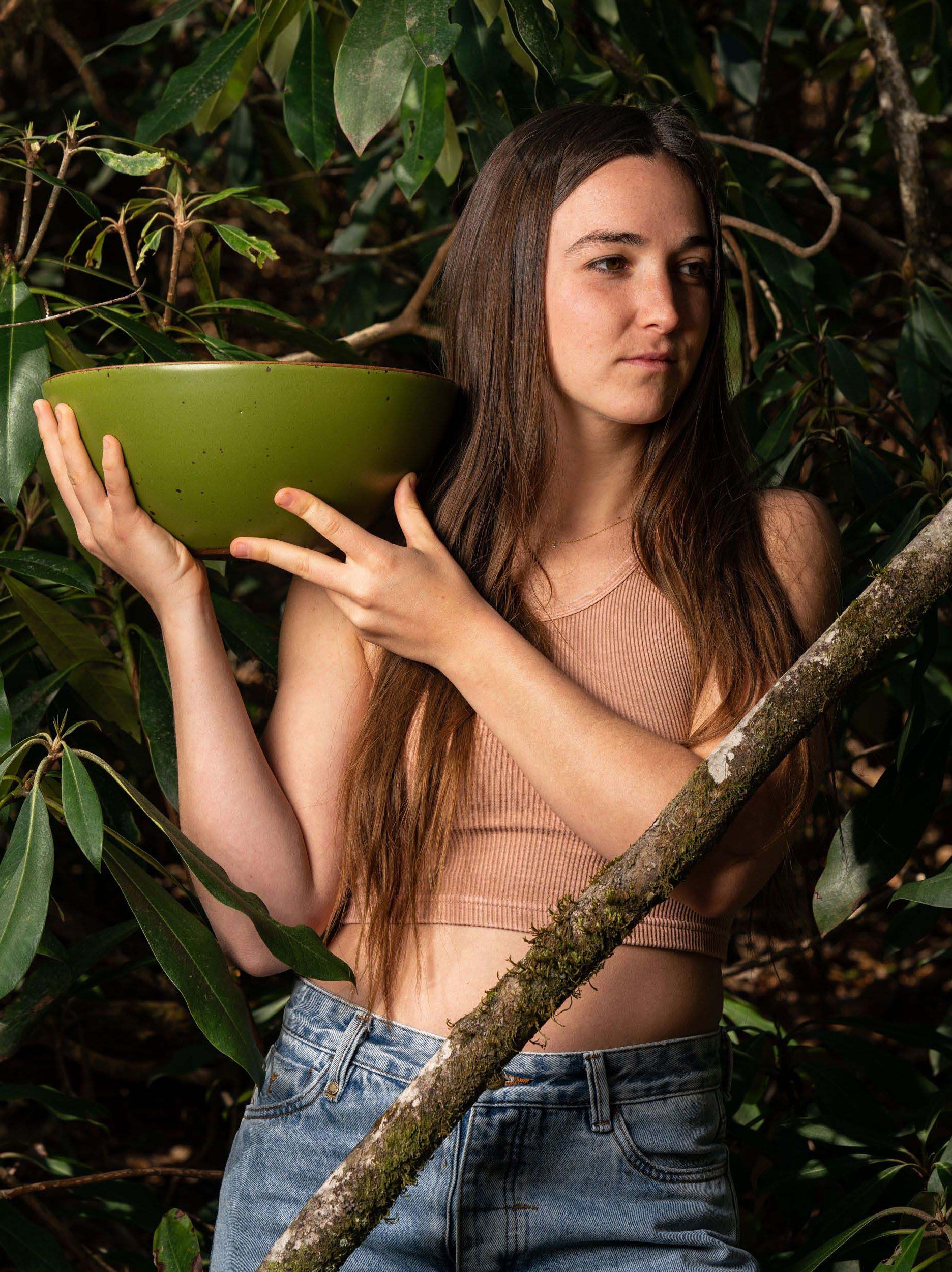 A young woman holds a Fiddlehead mixing bowl.