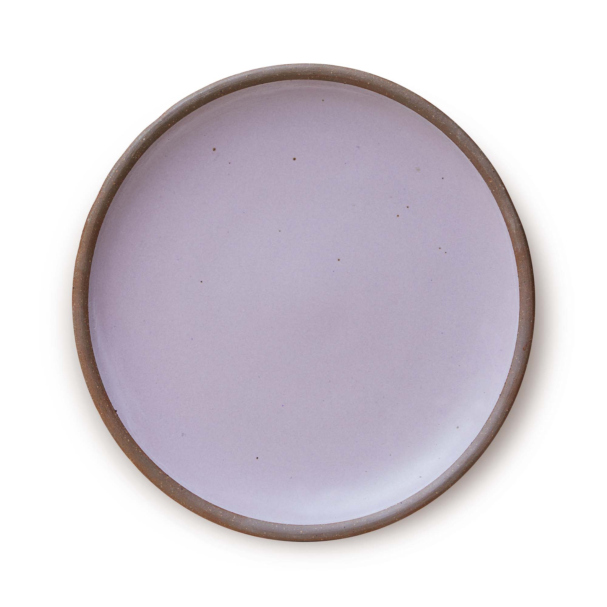 A large ceramic platter in a light purple color featuring iron speckles and an unglazed rim.