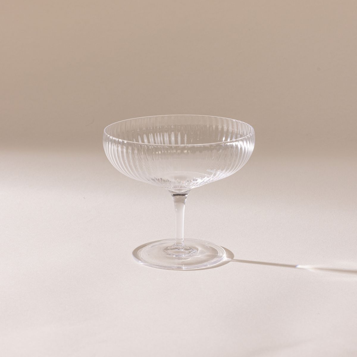 A delicate ribbed short coupe glass in the traditional style