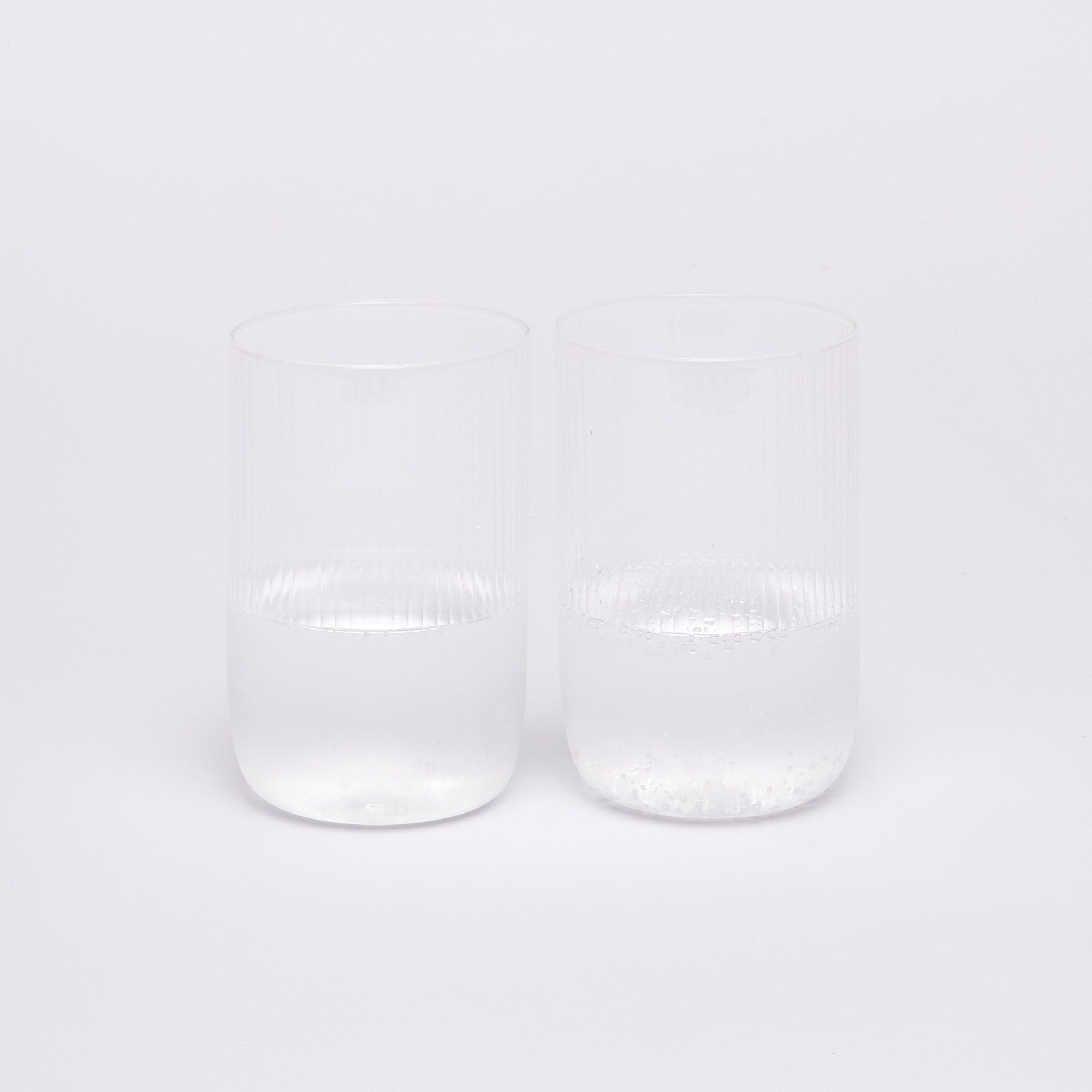 Two glasses half full of water
