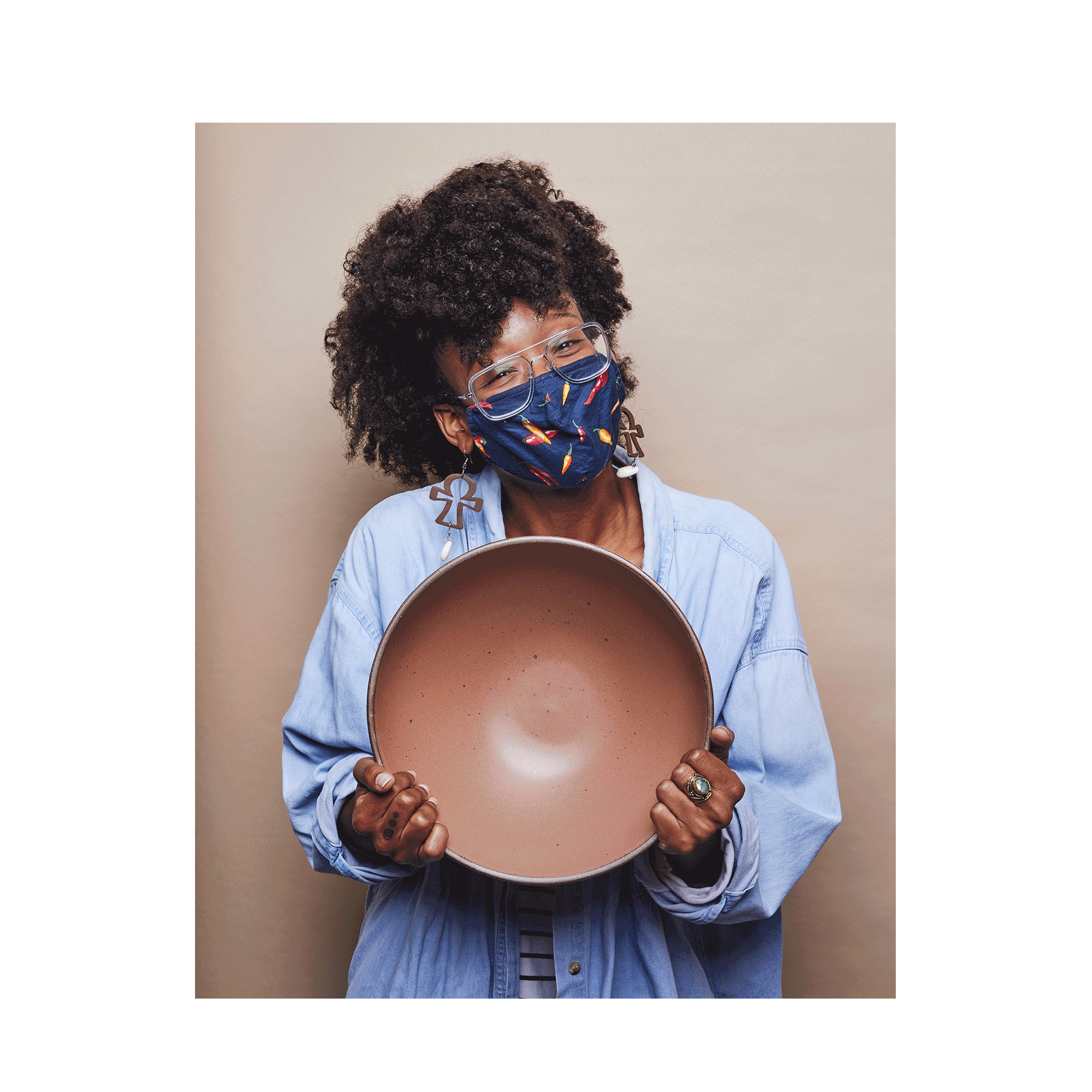 A gif featuring a person in a denim shirt holding a large bowl in a warm brown color